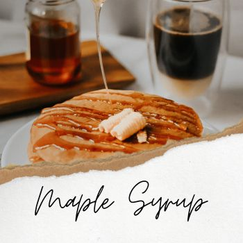 Image of syrup being drizzled on stack of pancakes with cup of coffee on the side