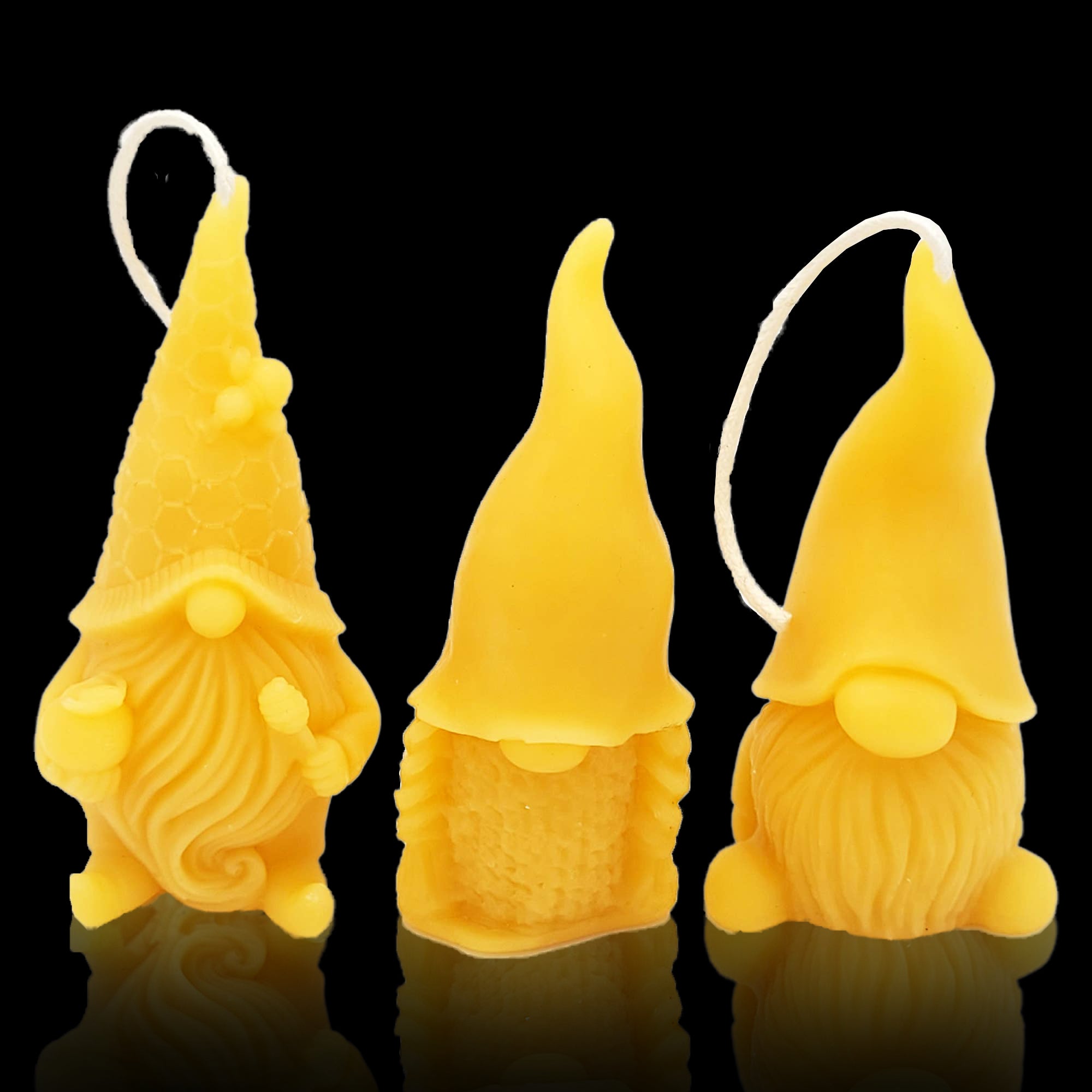 Honey - Beeswax Candle- Little Gnomes three sculptural gnomes candles on a black background. Higbee Honey