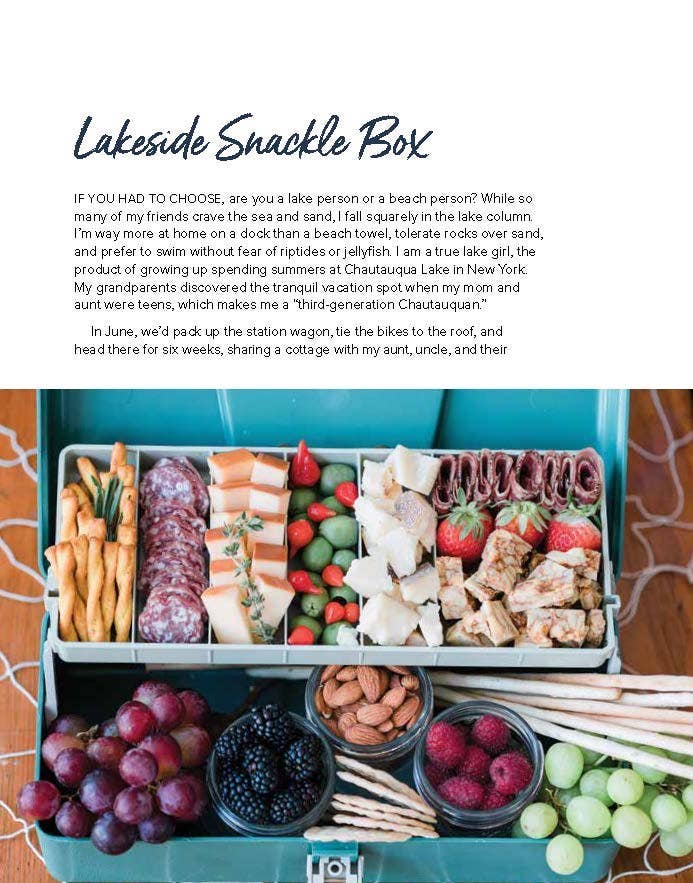 Accessories & Crocks - Gathering Boards: Seasonal Cheese And Charcuterie Spreads writeup for Higbee Honey including an image on the lower half of a scheese, hard salami, olicve, strawberry, nuts and grapes snack box still life photo.