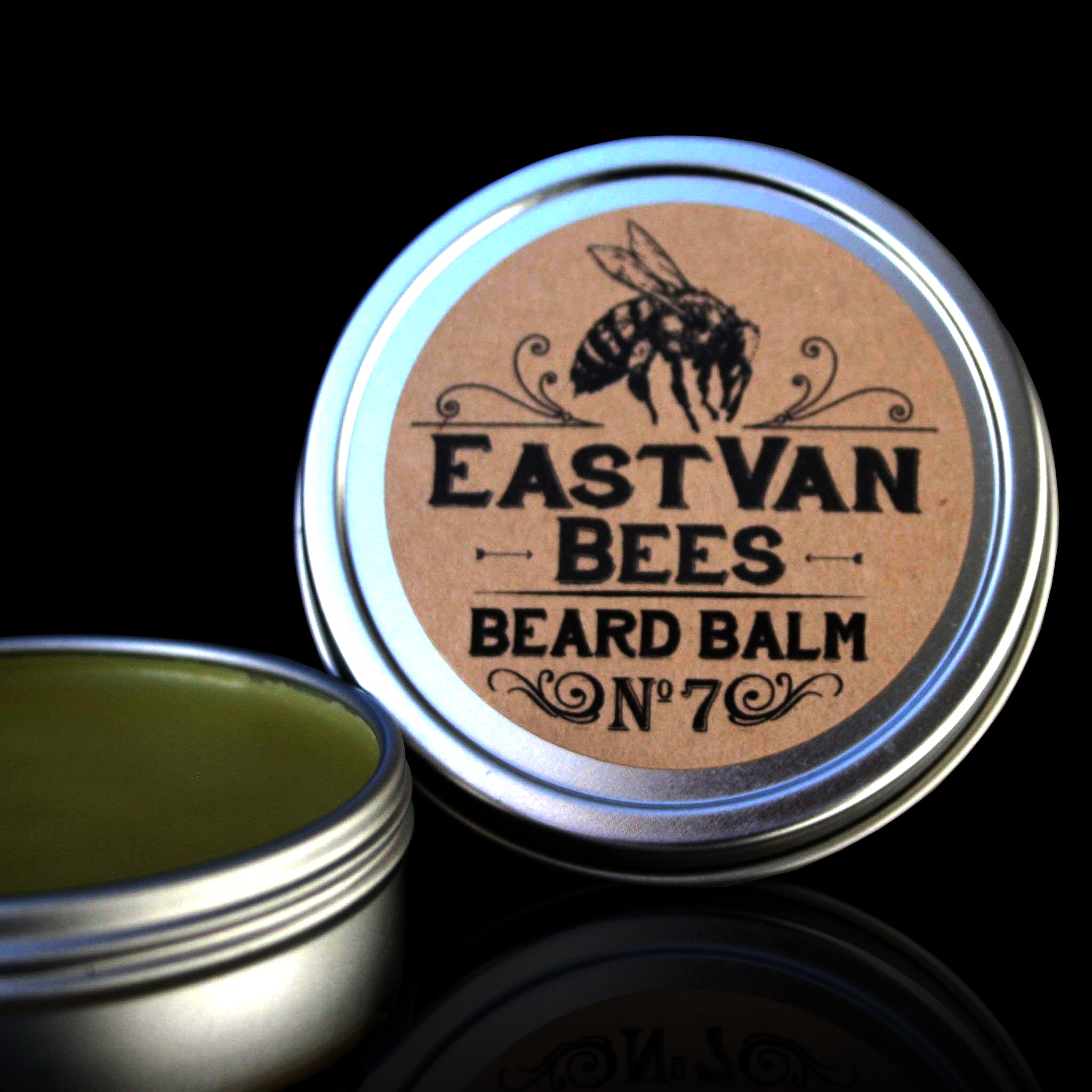 Accessories & Crocks - Beard Balm #7 by East Van Bees in a 2 oz. tin for Higbee Honey on a black background.