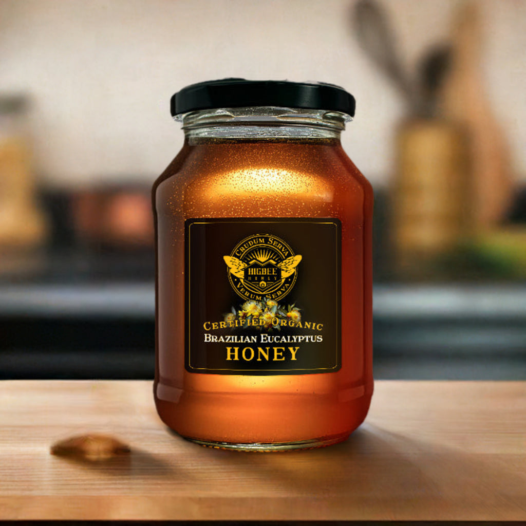 Honey - Brazilian Eucalyptus Organic Honey - Honey - Brazilian Eucalyptus Organic Honey jar with a black lid on a tabletop with lens blur and shallow focus 