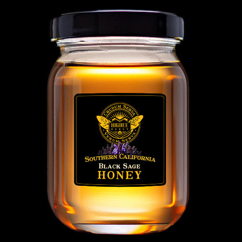 Honey - Southern California Black Sage Honey Pure, Raw, Unfiltered Wildflower Honey in a glass jar and black metal lid,  backlit and glowing golden amber colors by Higbee Honey on a black Background.