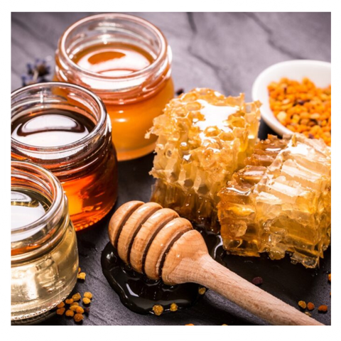 Image of honey in jars, honey dipper and honeycomb